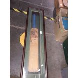 A signed cricket bat in wooden display unit. Catalogue only, live bidding available via our webiste.