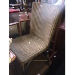 A gold coloured woven Lloyd Loom style chair Catalogue only, live bidding available via our webiste.