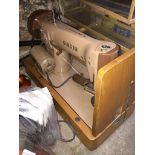 An electric Singer sewing machine - no power lead and no pedal. Catalogue only, live bidding