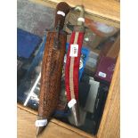 An Indian knife in a carved scabbard and another Catalogue only, live bidding available via our