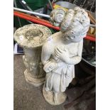 A concrete garden ornament of a lady on a plinth. The-saleroom.com showing catalogue only, live bid