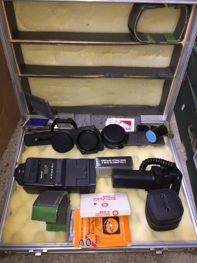 Metal case with camera accessories - no camera. The-saleroom.com showing catalogue only, live