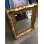 A gilt swept mirror The-saleroom.com showing catalogue only, live bidding available via our website.