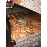 A vintage suitcase containing bed spread eiderdown. The-saleroom.com showing catalogue only, live