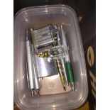 A tub of lighters and pens. The-saleroom.com showing catalogue only, live bidding available via