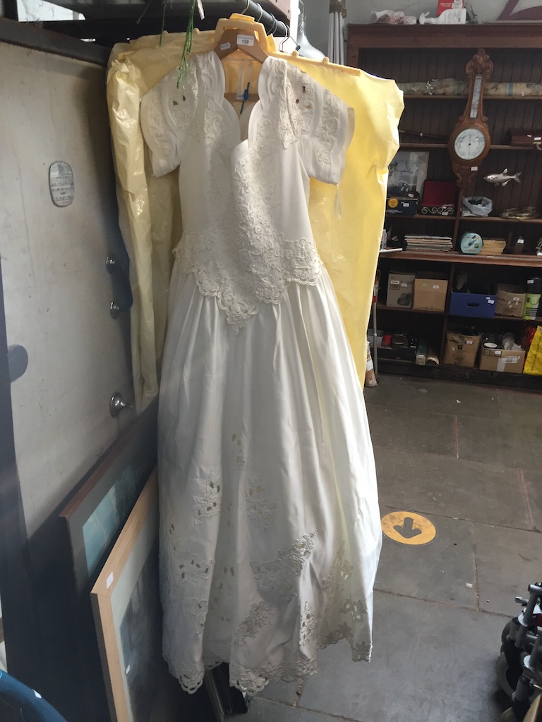 A wedding dress with long train The-saleroom.com showing catalogue only, live bidding available