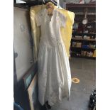 A wedding dress with long train The-saleroom.com showing catalogue only, live bidding available