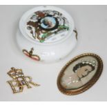 Queen Elizabeth II items comprising an Coronation brooch, a portrait brooch and Royale Garden