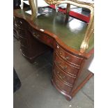 A reproduction pedestal desk of shaped form with tooled leather top The-saleroom.com showing
