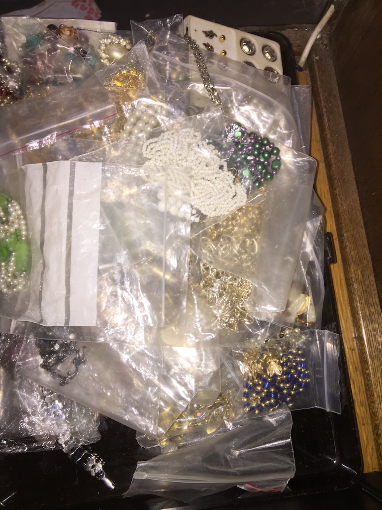 Plastic case of costume jewellery The-saleroom.com showing catalogue only, live bidding available