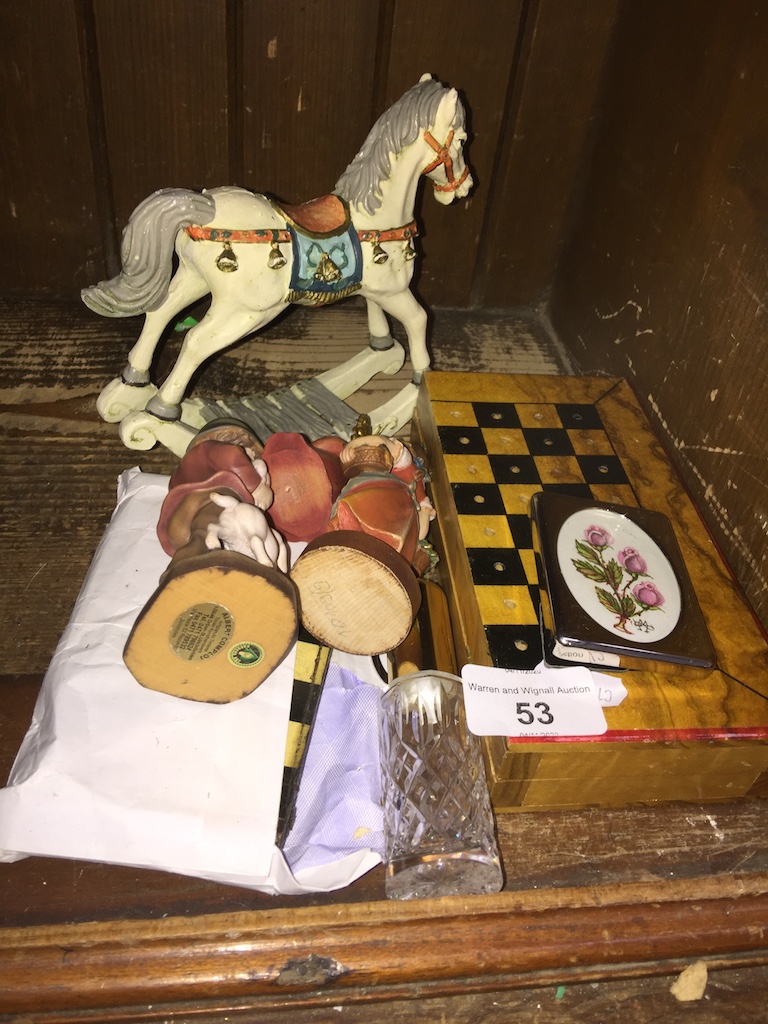 A wooden box travelling chess set, a draughts set and several small wooden figure ornaments The-