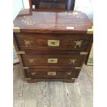 A brass inlaid small chest of drawers with inset campaign style handles The-saleroom.com showing