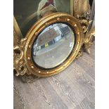 A Regency style convex mirror, length 78cm. The-saleroom.com showing catalogue only, live bidding