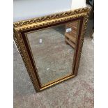 A gold framed mirror Catalogue only, live bidding available via our website, if you require P&P