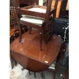 A reproduction mahogany dining table with four chairs Catalogue only, live bidding available via our