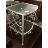 A wrought metal and glass two tier table Catalogue only, live bidding available via our website,