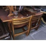 A Portwood Furniture Ltd teak extending dining table and four chairs Catalogue only, live bidding