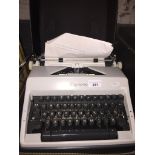 An Olympia portable type writer with case Catalogue only, live bidding available via our website, if