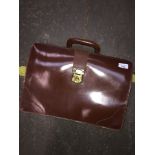 A small leather briefcase. Catalogue only, live bidding available via our website, if you require