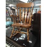 A light wood rocking chair Catalogue only, live bidding available via our website, if you require