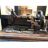 A 19th century hand cranked sewing machine, inscribed Longford family H.A. in wooden case