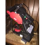 An electric chainsaw sharpener. Catalogue only, live bidding available via our website, if you