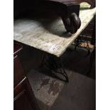 A Singer treadle base with stone effect top Catalogue only, live bidding available via our