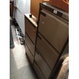 A large metal four drawer filing cabinet and a smaller veneered three drawer filing cabinet