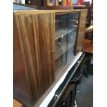 A teak cabinet with glass sliding doors Catalogue only, live bidding available via our website, if