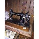 A hand cranked Singer sewing machine. Catalogue only, live bidding available via our website, if you