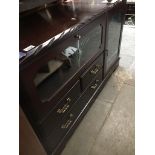 A dark wood reproduction sideboard/av unit Catalogue only, live bidding available via our website,