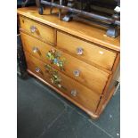 A decorated pine chest of drawers with glass handles Catalogue only, live bidding available via