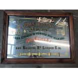A large advertising mirror - John Rogers pewterers and gas fitters, 54cm x 80cm. Catalogue only,