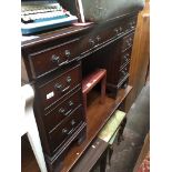 A reproduction pedestal desk with tooled green leather top Catalogue only, live bidding available
