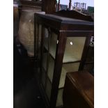 A glazed display cabinet on ball and claw feet. Catalogue only, live bidding available via our