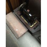 A vintage hand cranked Singer sewing machine in wooden case Catalogue only, live bidding available