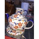 Teapot on stand and a jug Catalogue only, live bidding available via our website, if you require P&P