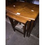 A walnut nest of tables Please note, lots 1-1000 are not available for live bidding on the-