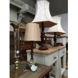 Three oak table lamps and a modern column candle stick Please note, lots 1-1000 are not available