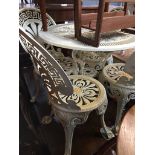 A cast metal patio table and four chairs Please note, lots 1-1000 are not available for live bidding