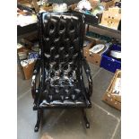 A buttoned leather slipper chair