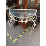 A wrought metal demi lune table with glass top Please note, lots 1-1000 are not available for live