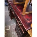 A reproduction pedestal desk with tooled red leather writing surface Please note, lots 1-1000 are