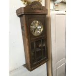 An oak cased wall clock - with key and pendulum Please note, lots 1-1000 are not available for