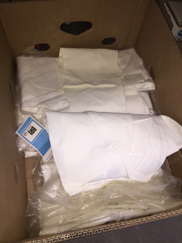 A box of protective dust suits. Please note, lots 1-1000 are not available for live bidding on the-