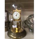 Brass revolving pendulum clock under a glass dome Please note, lots 1-1000 are not available for