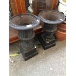 A pair of cast metal planters on stands Please note, lots 1-1000 are not available for live