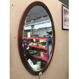An inlaid wood framed oval mirror Please note, lots 1-1000 are not available for live bidding on