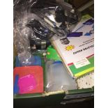 A box of mixed items including an adjustable folding board, a bag of cables, earphones, light bulbs,