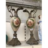 Pair of ornamental metal metal mounted ewers with painted glass